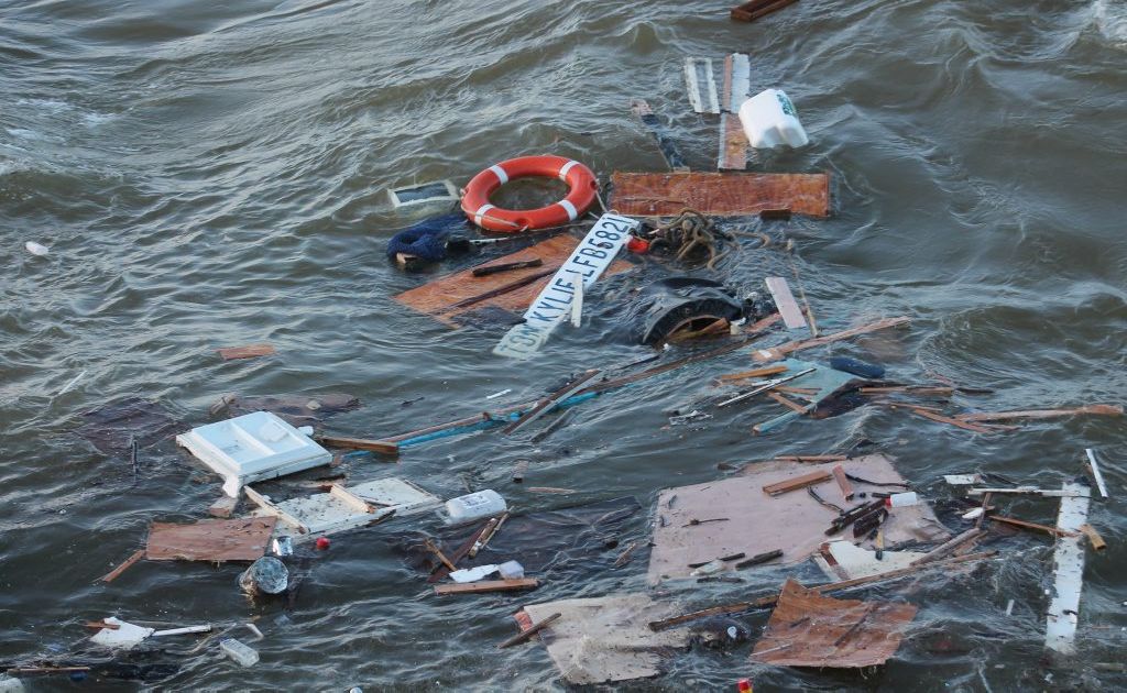 Surfers are risking their lives paddling past a sunken trawler at Duranbah Beach.
